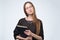 Student girl in glasses with long hair holding book preapring for exam.