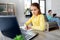 Student girl with laptop learning online at home