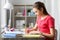 Student girl with ruler drawing line in notebook