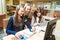 Student girls working with computer in library