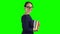 Student goes to school with books in her hands. Green screen. Side view