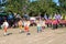 Student group of each school is walking in parade.