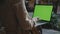 Student hands working laptop with green screen. Businesswoman typing on laptop