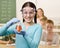 Student holding beaker of liquid in classroom