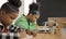 Student in international preschool writing a book together in Elementary School Class, Pupils enjoying studying in classroom