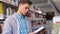 Student At Library. Man Looking Books On Bookshelves