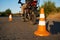 Student on motorbike, snake riding between cones