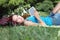 Student in park with digital book and headphones