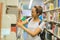 Student pulling book off shelf