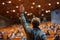 Student Raising Hand in University Lecture Hall.