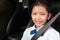 A student sit in the car with smiling