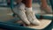 Student sitting at desk in classroom. Girl wearing white sneakers with socks