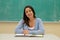 Student sitting in front of the blackboard