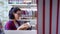 Student standing in library while reading book