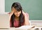 Student studying at desk in classroom