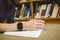 Student studying on floor in library wearing smart watch