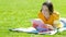 Student studying learning notes on the grass