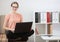 Student studying using a laptop sitting in the lotus position