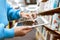 Student, tablet screen and library bookshelf of a woman at an education and knowledge center. University, college and