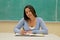 Student taking notes in the classroom blackboard