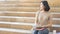 student teen girl with education book and coffee cup sit on stair pedestrian