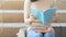 student teen girl with education book and coffee cup sit on stair pedestrian