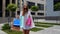 Student teen girl with shopping bags. Good Black Friday holiday sale discounts, low price purchases