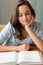 Student teenage girl reading book at home