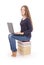 Student teenage girl sitting sideways on the book with laptop