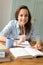 Student teenage girl studying at home smiling