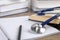 Student textbook, blank notebook, pencil and stethoscope on wooden table, closeup. Medical education