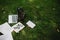 Student or tools on green grass: laptop, backpack, notebook, smartphone, empty sheets of paper