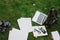 Student or tools on green grass: laptop, backpack, notebook, smartphone, empty sheets of paper