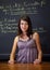 Student, university and classroom for mathematics, chalkboard and ready for class, woman or lecture. Portrait, education