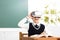 Student with virtual reality headset sitting in classroom