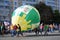 Student walk with a huge balloon.