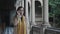 Student walking in colonnade hallway.Businesswoman putting on eyeglasses outside