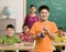 Student wearing goggles holds beaker of liquid