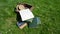 Student woman books grass