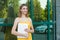 Student young girl woman holding books laptop smiling outside