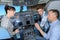 Students asking questions in aircraft cockpit