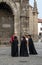 Students in black robes talking with the tourists in front of Braga Cathedral SÃ© de Braga