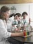 Students Caring Out Experiments In Laboratory