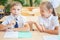 Students or classmates in school classroom sitting together at desk