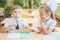 Students or classmates in school classroom sitting together at desk