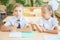 Students or classmates in school classroom sitting together at desk