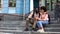 Students couple hugging, sitting on university building stairs, youth love