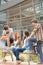 Students friends sitting bench front of university