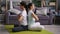 Students girl and guy meditating sitting on floor back to back with closed eyes