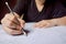 Students hand holding pencil writing selected choice on answer sheets and Mathematics question sheets. students testing doing